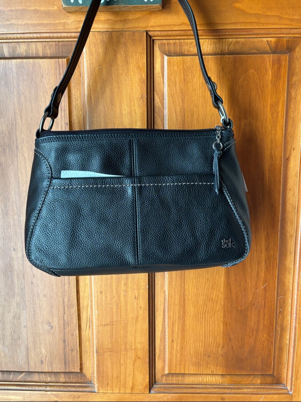 The SAK genuine black leather purse. NWT.